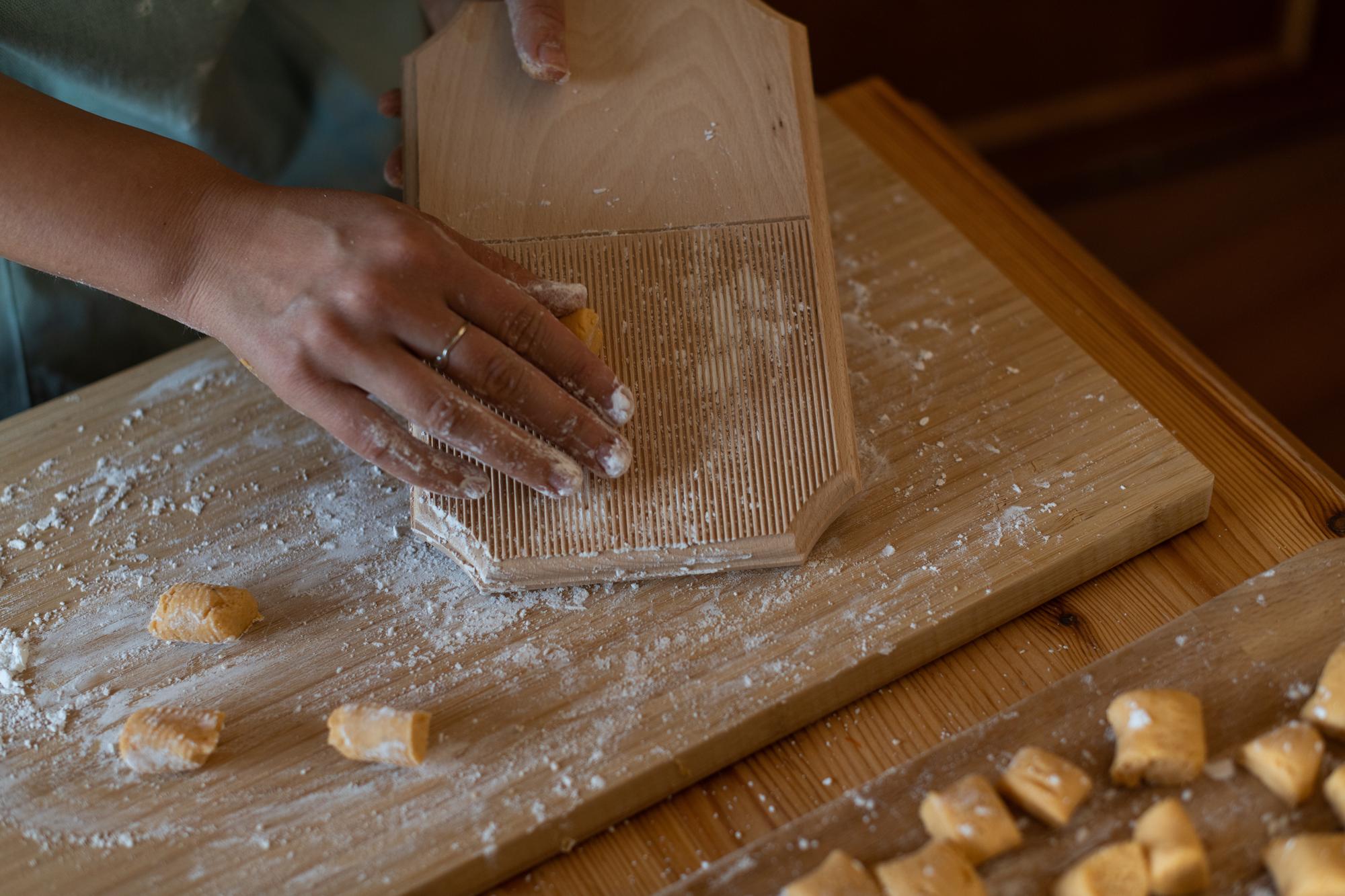 Close-up of hands shaping pasta dough
