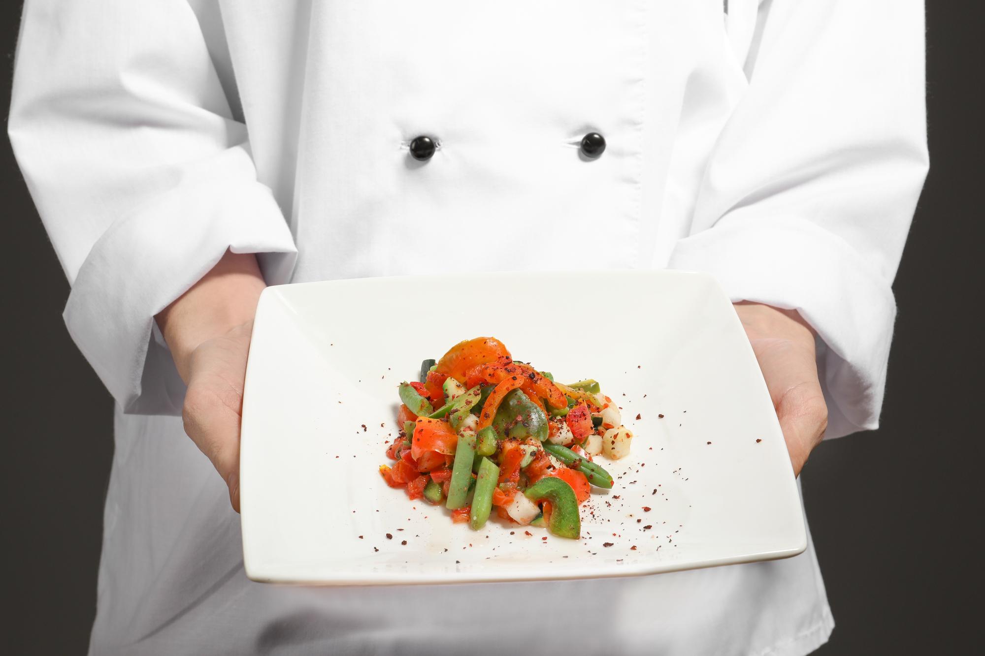 Chef preparing plated dish in studio kitchen